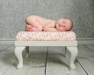 newborn photography studio - newborn on poufy